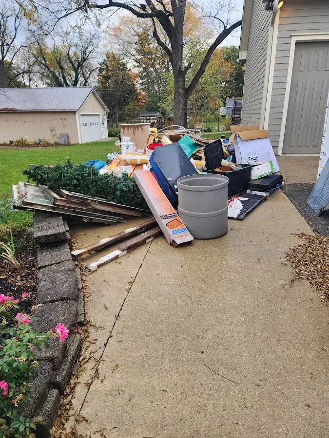 Dumpster being loaded with debris for Estate Cleanout Dumpster Rental in Port St. Joe